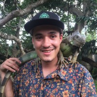 John holding a curious Green Iguana. Reptile Park, Ubud, Bali