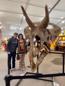 Alisha and John posing beside a Triceritops Skull.