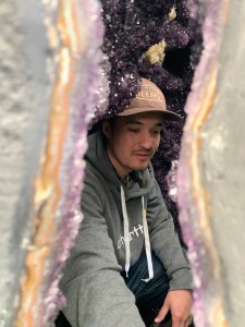 John looking out from inside a giant amethyst geode.