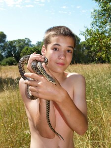 John at 10 catches a gopher snake on a hike near Mendocino, California