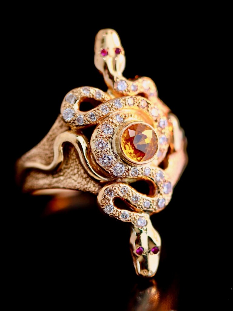 14K gold Alpha Omega Snake Ring with paved diamonds. pink sapphire and ruby eyes